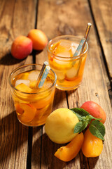 Delicious refreshing drink with apricot on wooden table