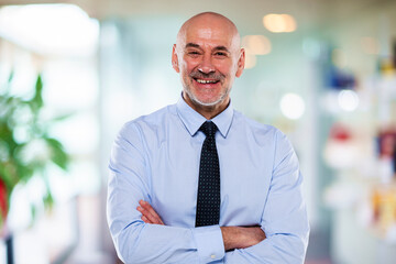 Middle aged businessman standing at the office