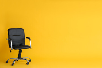 Modern office chair on yellow background. Space for text