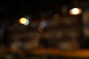 Blurred view of stylish modern bar interior with bokeh effect