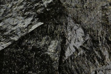 Dry nori sheets as background, closeup view