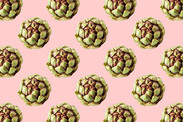 Fresh green artichokes on pink background. Seamless repeating pattern.