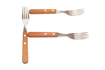 Naklejka premium 3 forks with wooden handles making the letter F on a white background