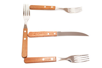 3 forks and 1 knife with wooden handles making the letter E on a white background