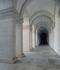 White archway colonnade in courtyard of Convento de Nossa Senhora da Graca, Lisbon, Portugal.