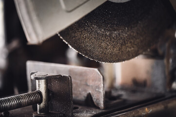 Selective focus on chop saw abrasive blade used for cutting metal.