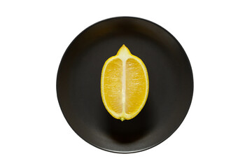 Lemon cut lengthwise, on gray plate, isolated on white background with clipping path, top view.