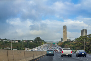 Fototapeta premium Highway road with big city background at Honolulu, Hawaii