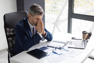 Business Failure. Depressed Middle Aged Businessman Sitting At Desk In Office