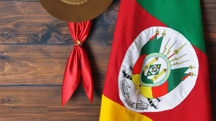 Flag of the state of Rio Grande do Sul -Brazil (on fabric), hat and gaucho scarf, on a brown...