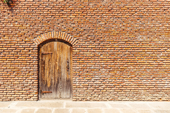 Old medieval door in rustic brick wall. Castle Rabat, Georgia.
