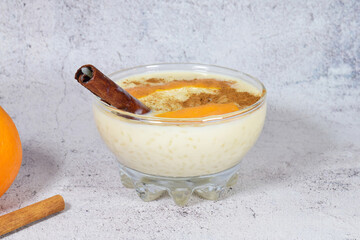 	
Delicious rice pudding with cinnamon and with a touch of orange, presented in a bowl.	