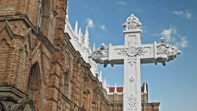 Dolly in shot of a stone cross at The Cathedral of Our Lady Saint Anne located in Santa Ana, El Salvador