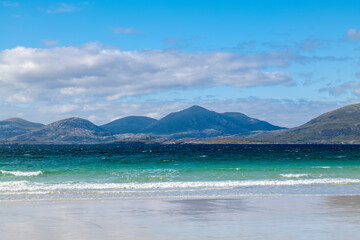 Fototapeta na wymiar 16 August 2022. Isle of Harris, Highlands and Islands, Scotland. This is a beach and the mountains on the Isle of Harris on an August sunny afternoon.