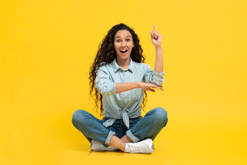 Excited Female Having Idea Pointing Finger Up On Yellow Background