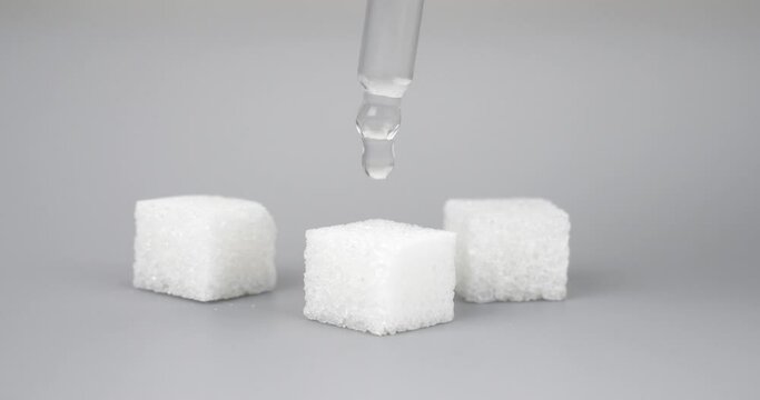 a drop of lsd dripping into a sugar cube. High quality 4k footage