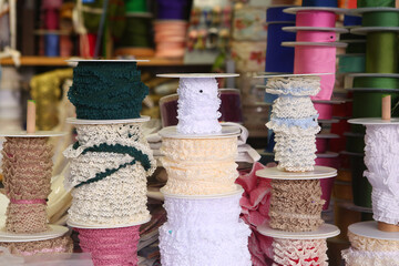 laces and ribbons assortment in the shop for sewing craftsmanship close up photo