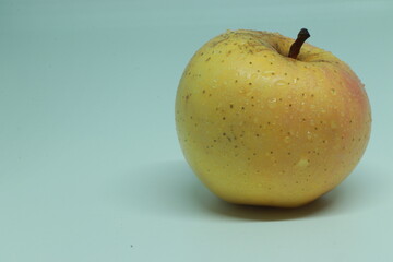 Ripe yellow apple on white.