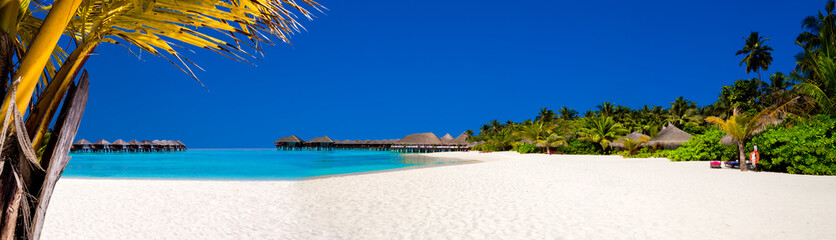 Landscape on Maldives island, luxury water villas resort and wooden pier. Beautiful sky and ocean...