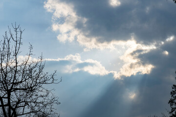 the sun's rays make their way through the dark clouds