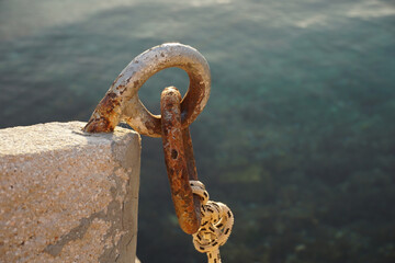Cleat with loop and rope for tying smaller boats and ships on the seashore