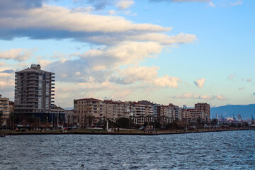 Fototapeta premium Mountains and the Aegean Sea on the coast of Izmir with copy space and appartment buildings