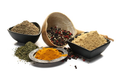 Turmeric powder, ginger ground,  anise seeds, colorful pepper in calabash gourd half and pile dry chopped parsley isolated on white