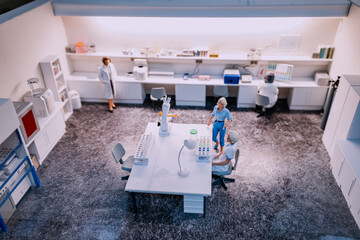 Chemical or medical toy laboratory with various equipment and professionals