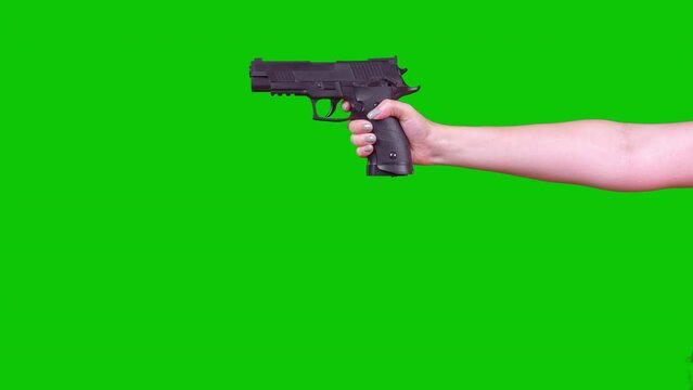 A Woman Holds A Pneumatic Pistol On A Green Screen In Her Hand