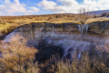 Frozen waterfall in the wild. Landscape background with copy space