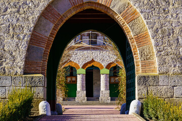 Fototapeta premium Stone arch at the entrance to the old stone church. Background with selective focus and copy space
