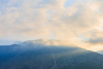 Obraz premium Very beautiful evening view of the mountain with haze at sunset with sun flare in Turkey. Background