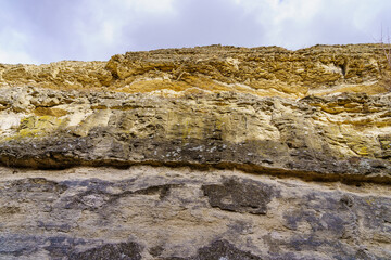 Texture cracked rock formation rock in the wild. Background with copy space