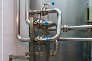 A stainless steel pipe system in the food industry at a brewery in the process of brewing beer. Background