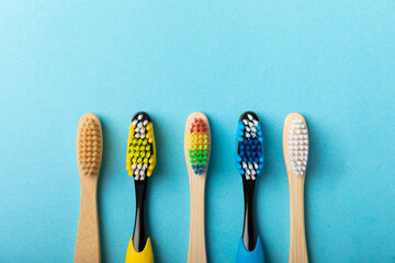 Toothbrushes. Oral care. Dental care. Composition with different toothbrushes on a blue background. Teeth love concept.Copy space. Place for text.Fletley