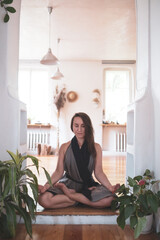 woman practicing yoga lesson, breathing, meditating, doing Padmasana exercise