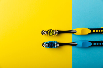 Toothbrushes. Oral care. Dental care. Composition with toothbrushes on a yellow-blue background.Space for copy. Place for text.Fletley