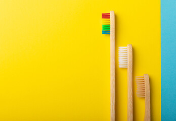 Toothbrushes. Oral care. Dental care. Composition with bamboo toothbrushes on a yellow background. Eco friendly.Copy space. Place for text.Fletley