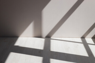 Stimulate scene of white empty room with sun light cast shadow on the laminate wood wall