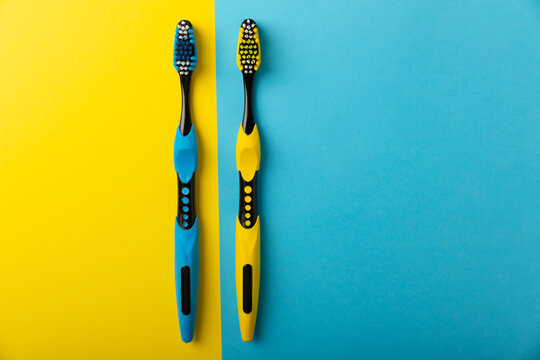 Toothbrushes. Oral care. Dental care. Composition with toothbrushes on a yellow-blue background.Space for copy. Place for text.Fletley