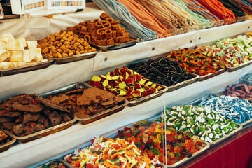 Outdoor shop of colourful sweets made of chocolate, jelly and marmalade.