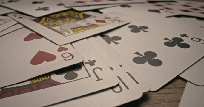 Macro shot. Extremely close up of pile of play cards. Card is falling on a table during game. Casino poker game. Gamble lifestyle. Gaming. Gambling business concept. Leisure. Playing risky game
