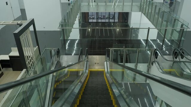 Using Escalator. Point Of View Or POV Video Footage. Close Up Shot Of Empty Moving Staircase Running Up And Down. Modern Escalator Stairs Move Indoors Going Up And Down. Escalator With Glass Sides.