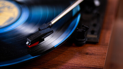 Record with a blue hue on a turntable with needle