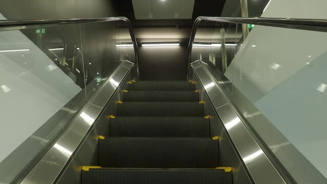 Using Escalator. Point Of View Or POV Video Footage. Close Up Shot Of Empty Moving Staircase Running Up And Down. Modern Escalator Stairs Move Indoors Going Up And Down. Escalator With Glass Sides.