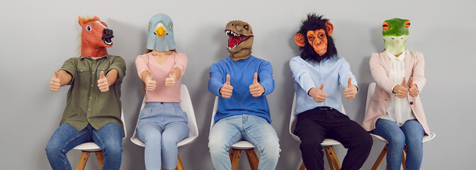 Team of quirky people with funny animal faces doing like gestures. Group portrait of happy young...