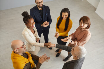 Top view of smiling diverse business partners handshake greet get acquainted at office team...