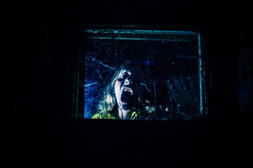scary woman behind window  at night Halloween horror background