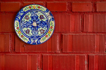 ceramic plate on red wall