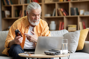 Elderly man seating on sofa, making distant video call